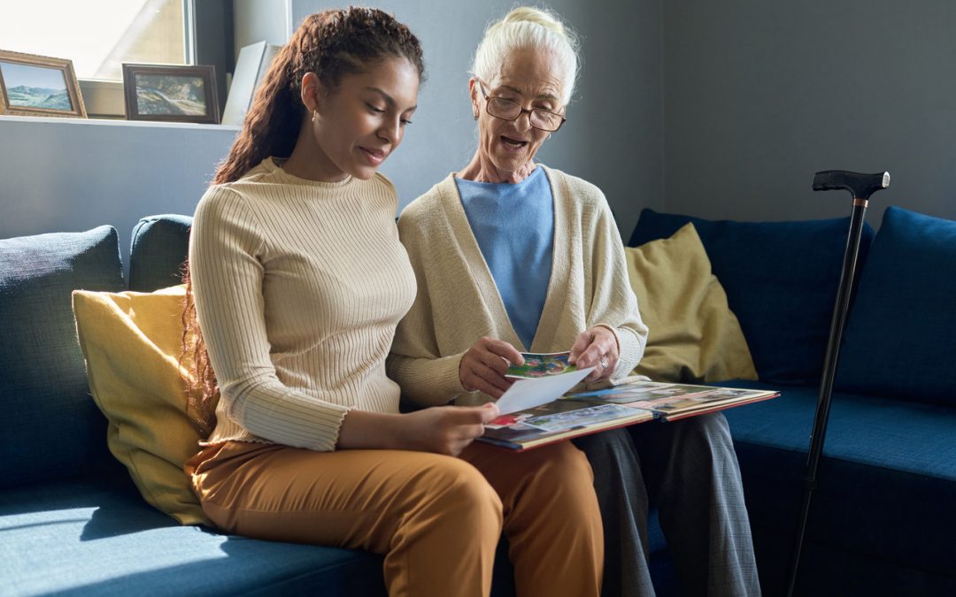 senior woman and teenager sitting together